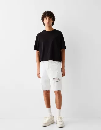 Bermuda in denim strappato