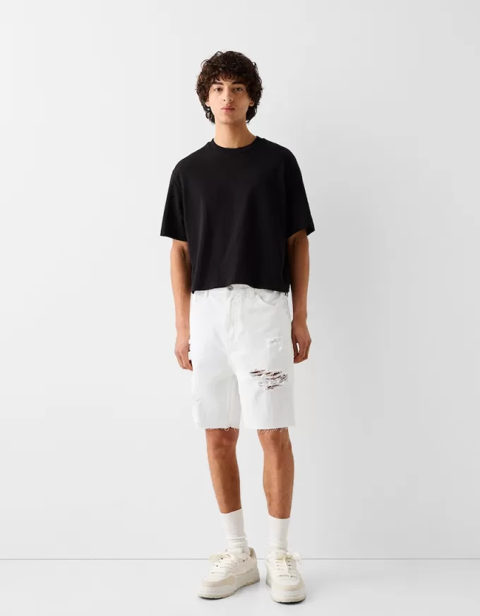 Bermuda in denim strappato