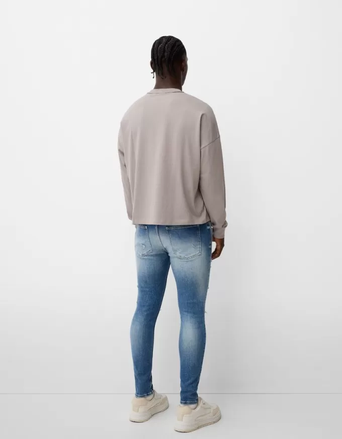 Jeans super skinny strappati