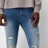 Jeans super skinny strappati