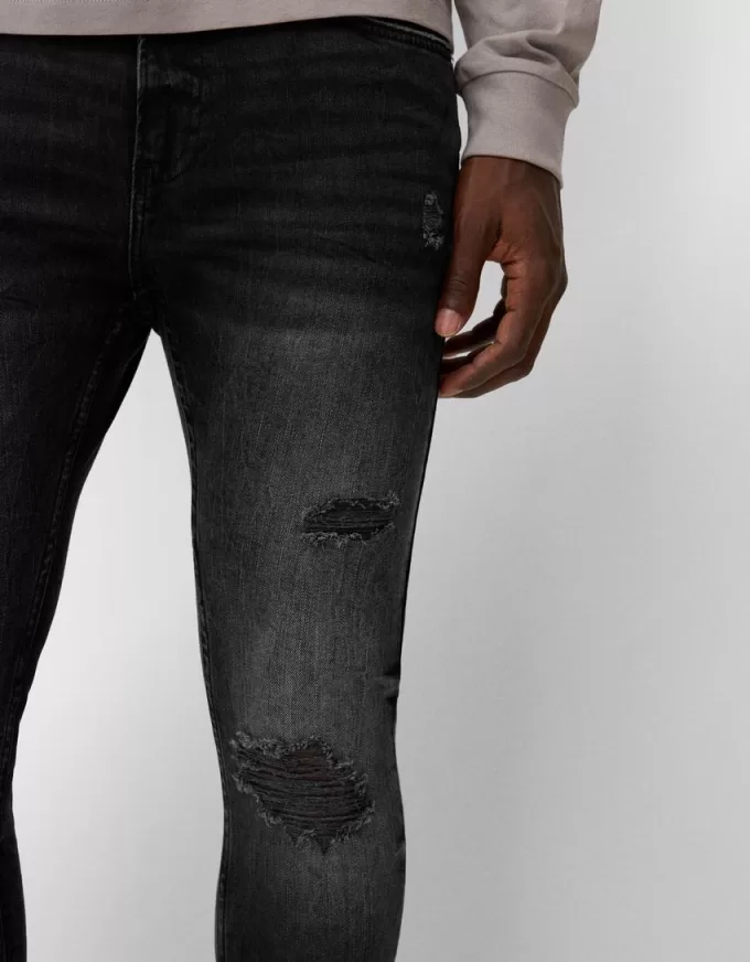 Jeans super skinny strappati