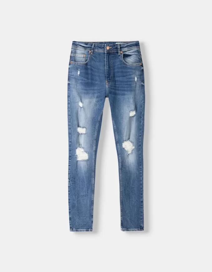 Jeans super skinny strappati