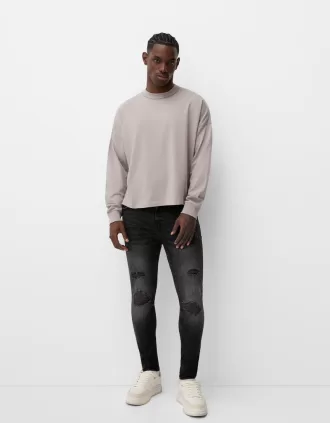 Jeans super skinny strappati