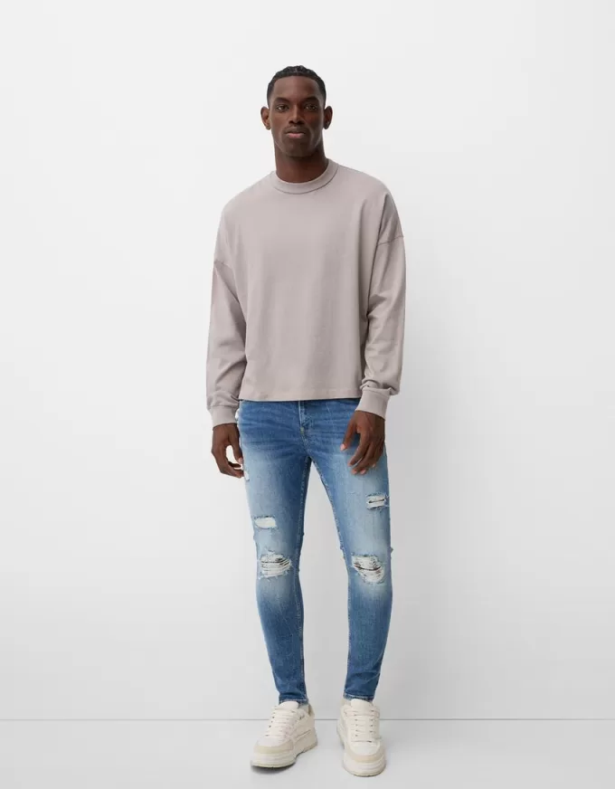 Jeans super skinny strappati