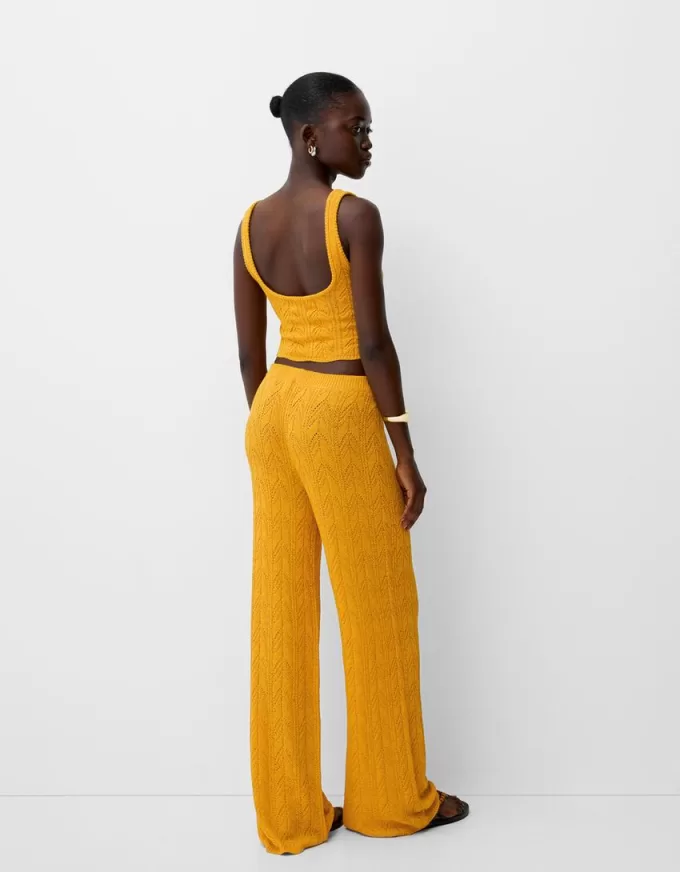 Pantaloni rustici svasati in maglia aperta