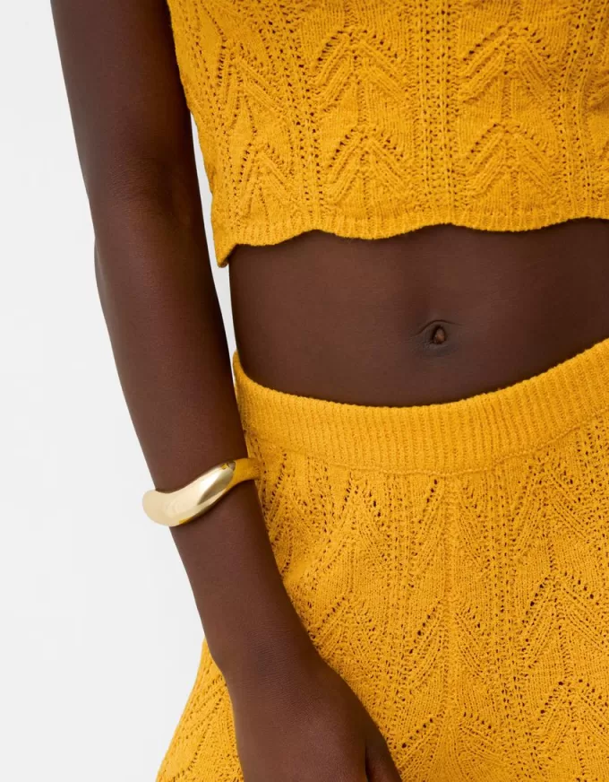 Pantaloni rustici svasati in maglia aperta